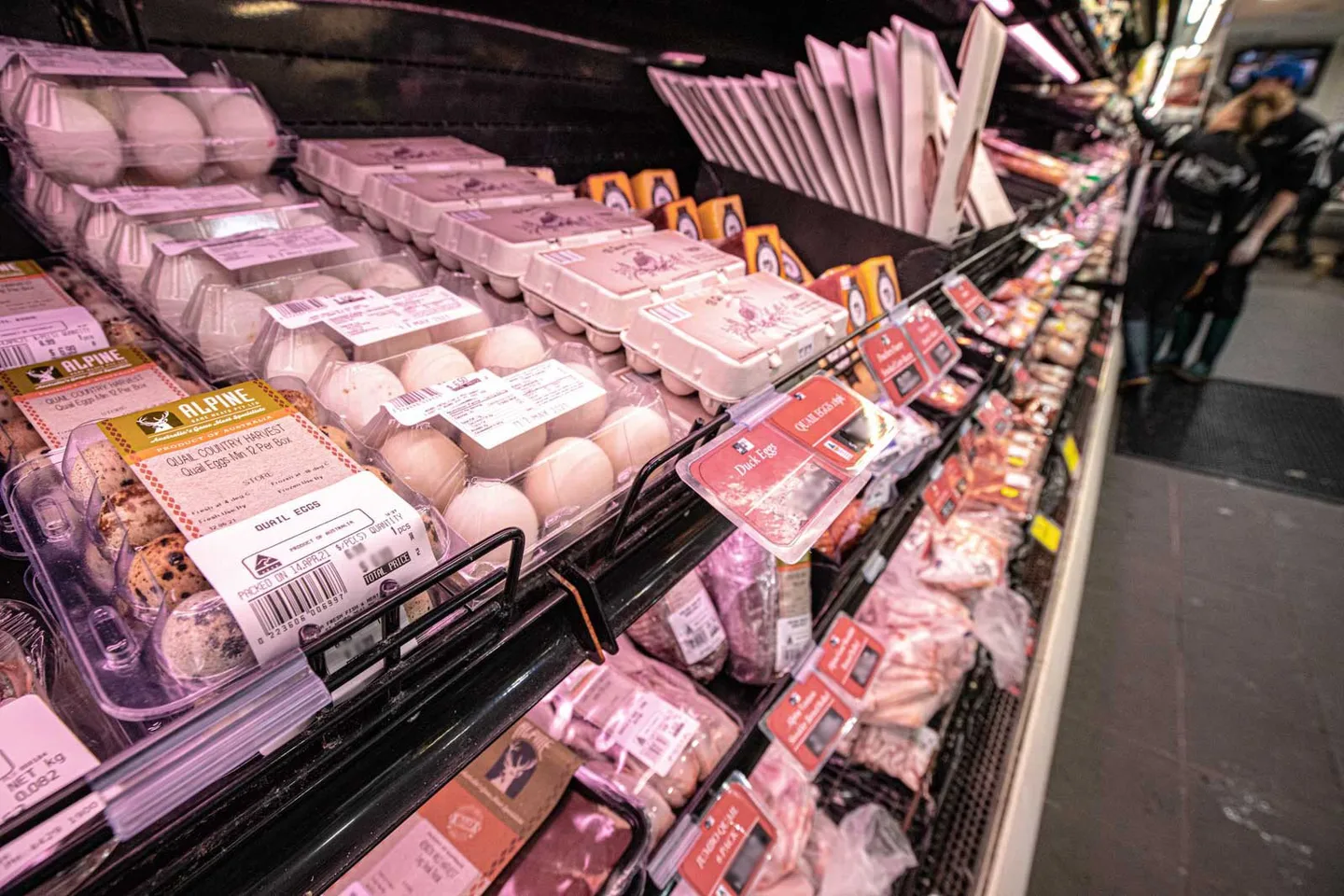 Packaged chicken and free range eggs in a chilled display case