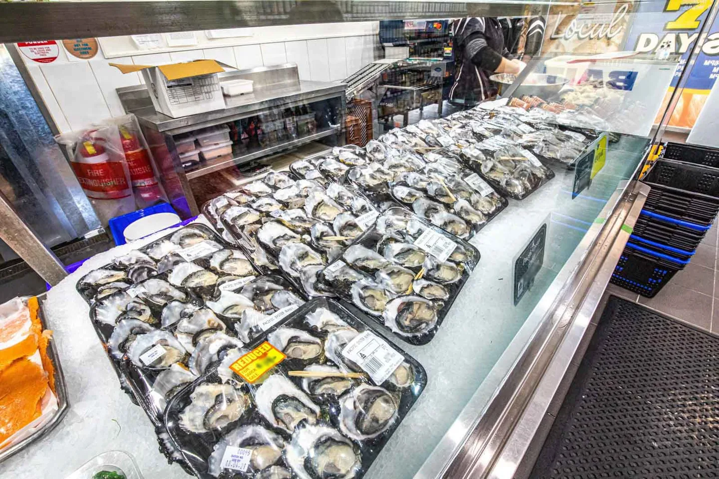 Oysters on the half shell packed on ice in the seafood cabinet