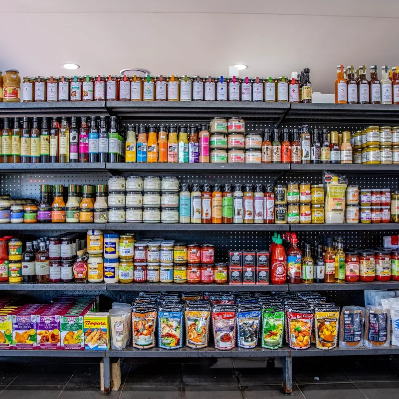 Shelves of bottled sauces, oils, mustards and vinegars