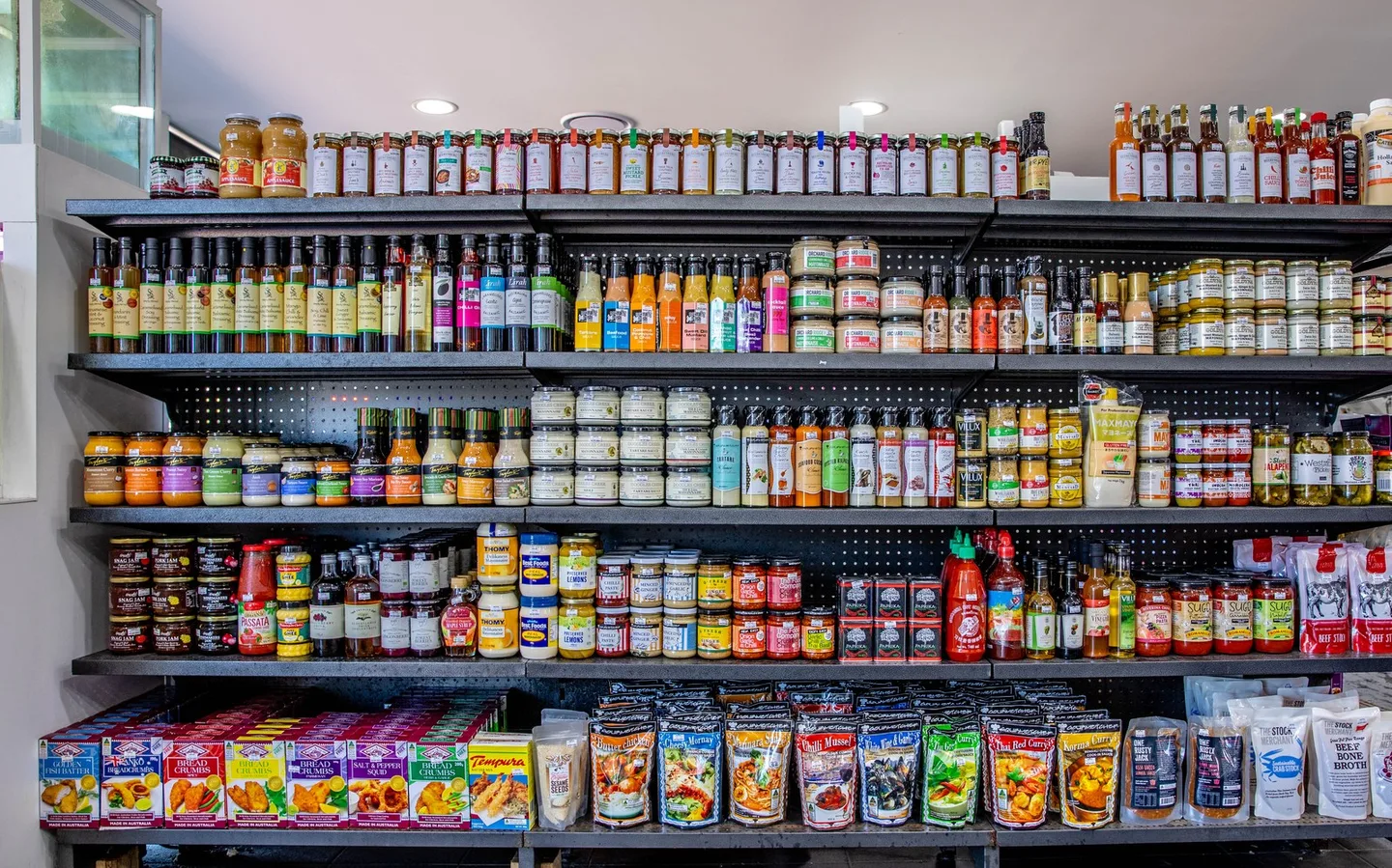 Shelves of bottled sauces, oils, mustards and vinegars