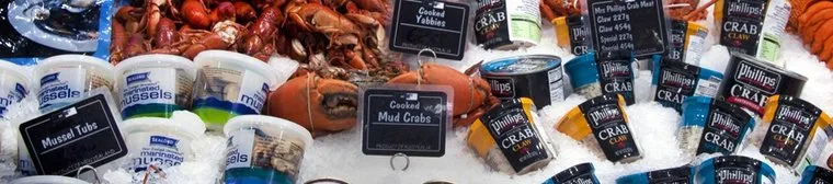 Tubs of marinated mussels and tins of crab meat packed on ice