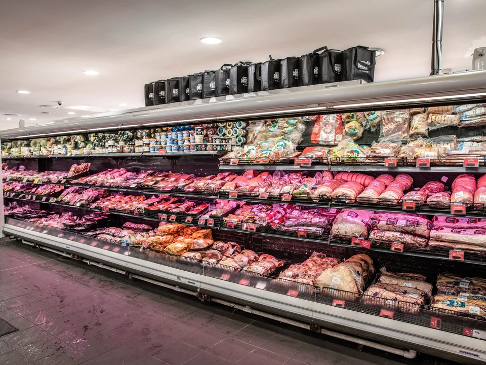 The refrigerated meat cabinet stacked with trays of beef, pork and lamb